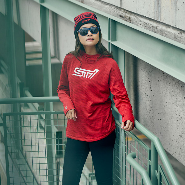 Photo of a woman wearing athletic gear, featuring a bright red ultralight hoodie